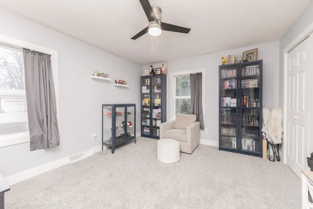 a living room with furniture and a book shelf