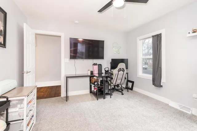 a view of a livingroom with workspace and a window