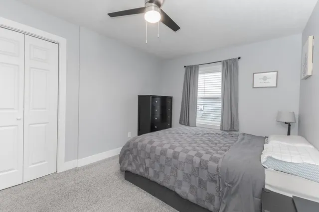 a bedroom with a bed and a closet