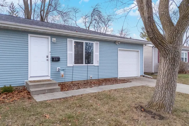 a view of a house with a yard and garage
