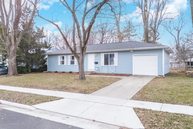 a house that has a tree in front of it