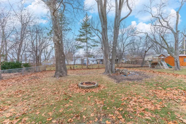 a view of a yard with a tree