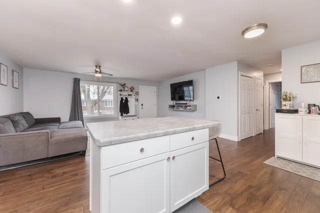 a kitchen with granite countertop a sink and a stove top oven