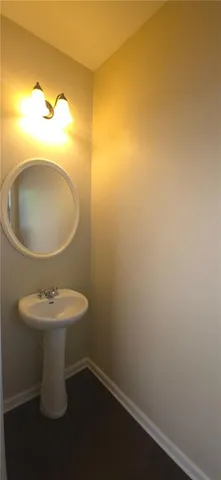 a bathroom with a sink toilet and a mirror