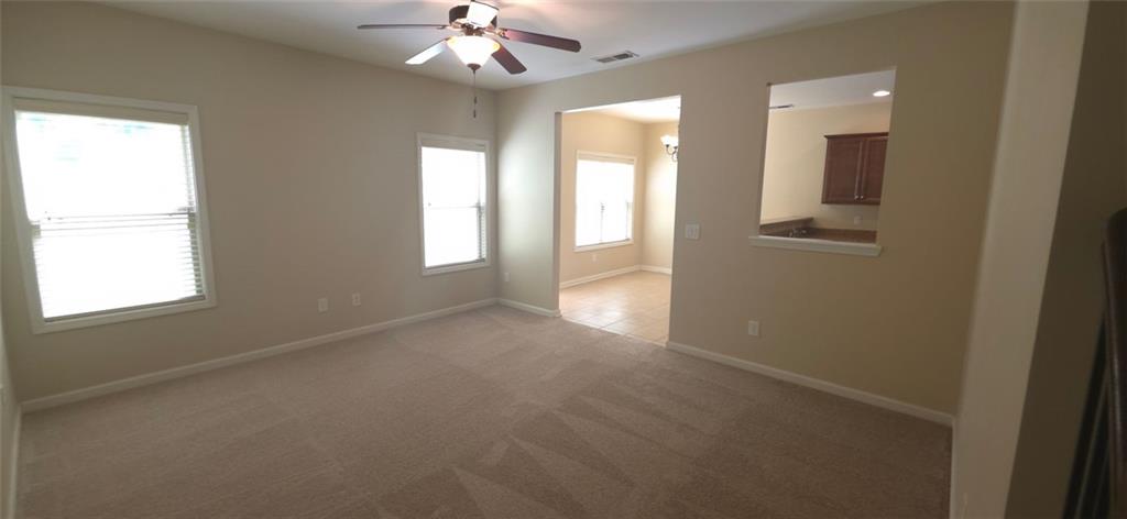 539 Broughton Drive Canton, GA 30114 - Photo 2 of 14 en empty room with windows and chandelier fan