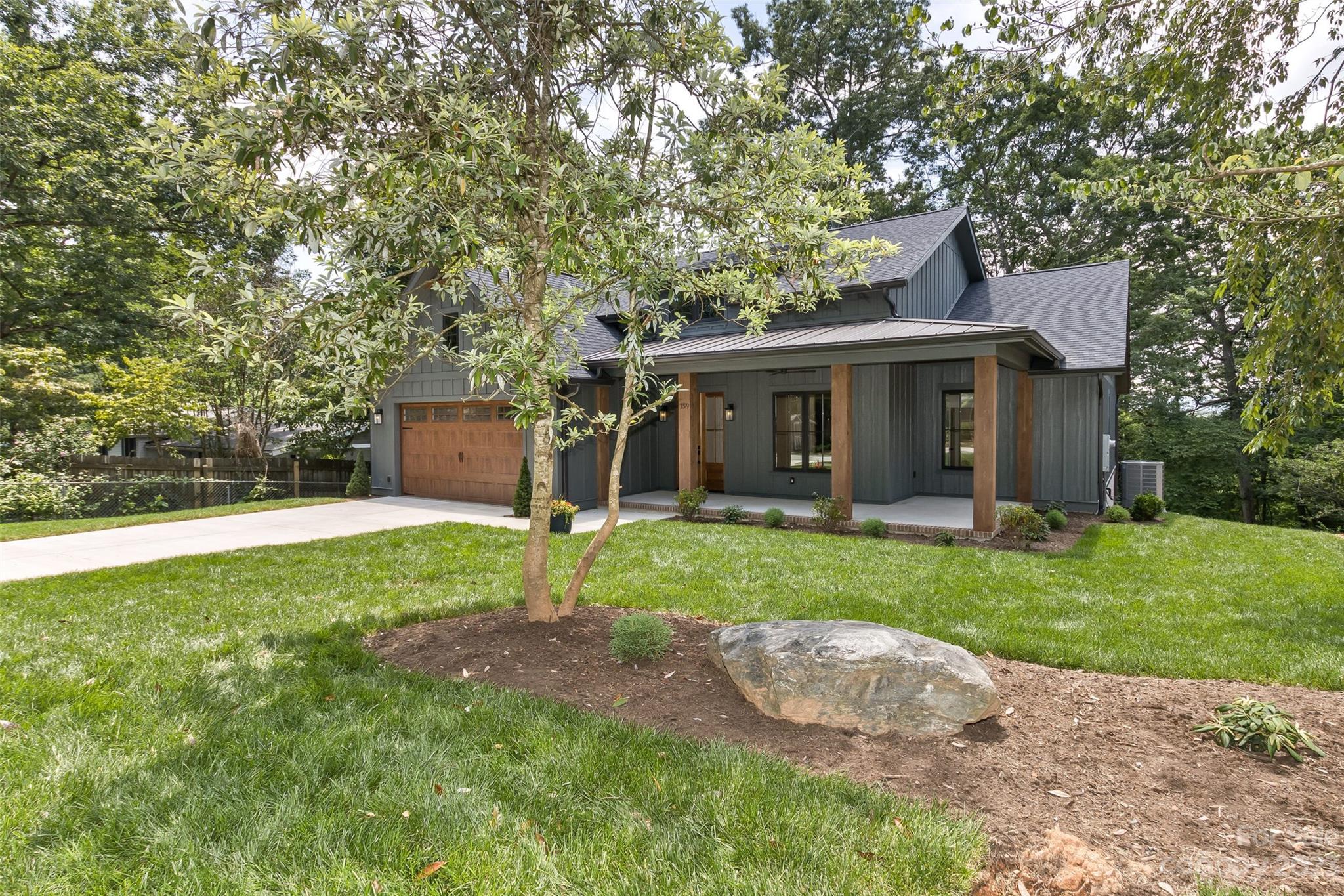 159 Gashes Creek Road Asheville, NC 28805 - Photo 2 of 48 a view of a house with a yard and a large tree