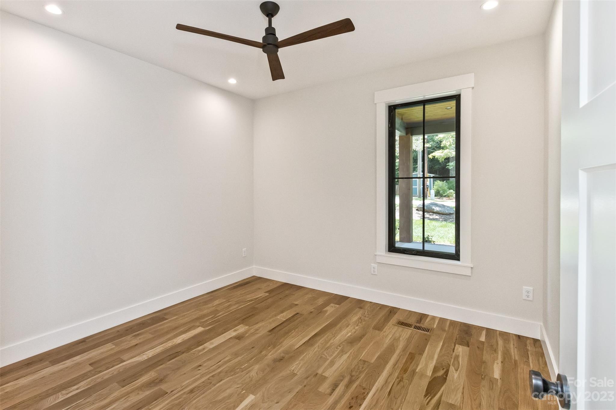 159 Gashes Creek Road Asheville, NC 28805 - Photo 33 of 48 an empty room with a window and ceiling fan