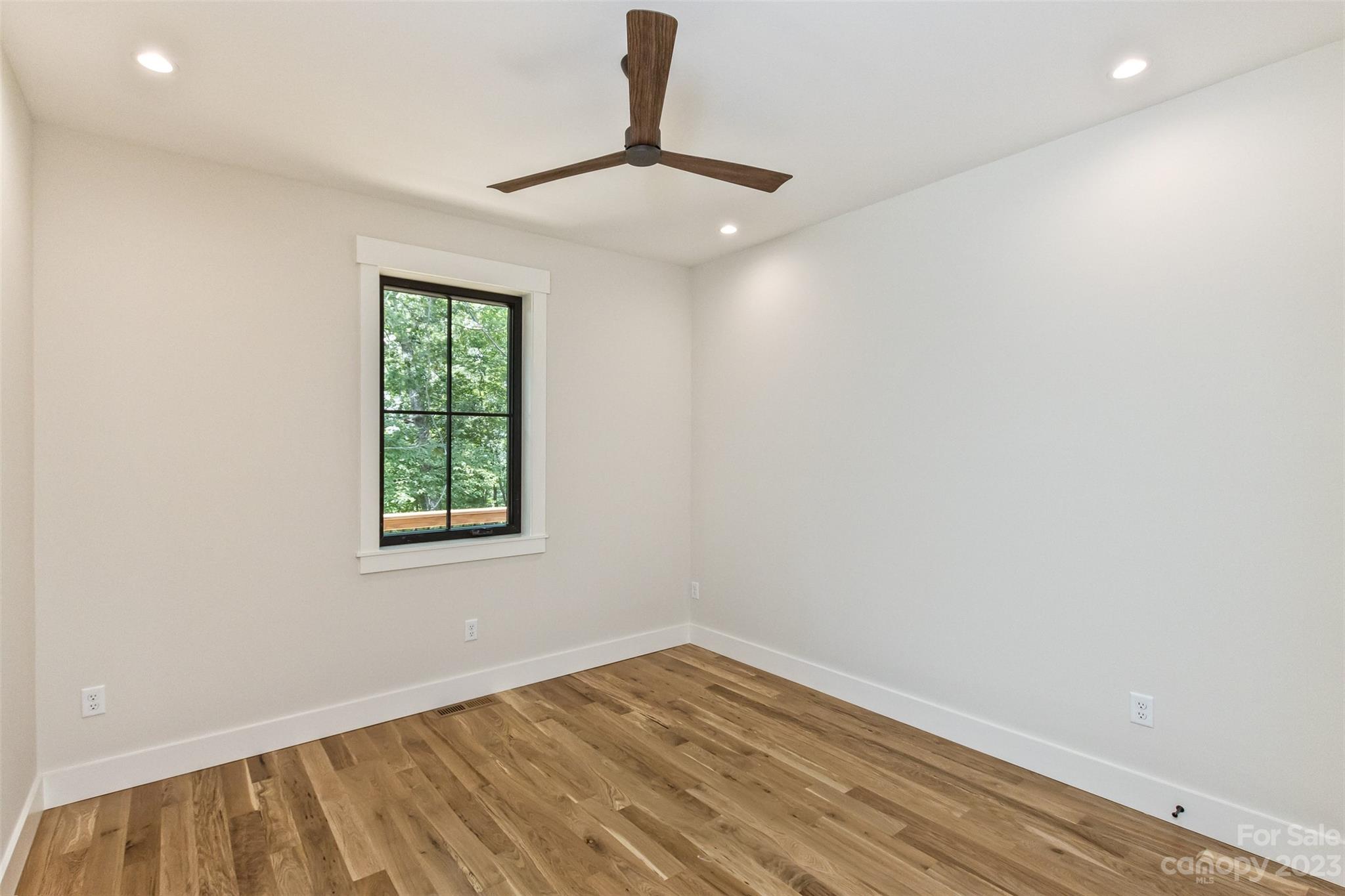 159 Gashes Creek Road Asheville, NC 28805 - Photo 35 of 48 wooden floor in an empty room with a window
