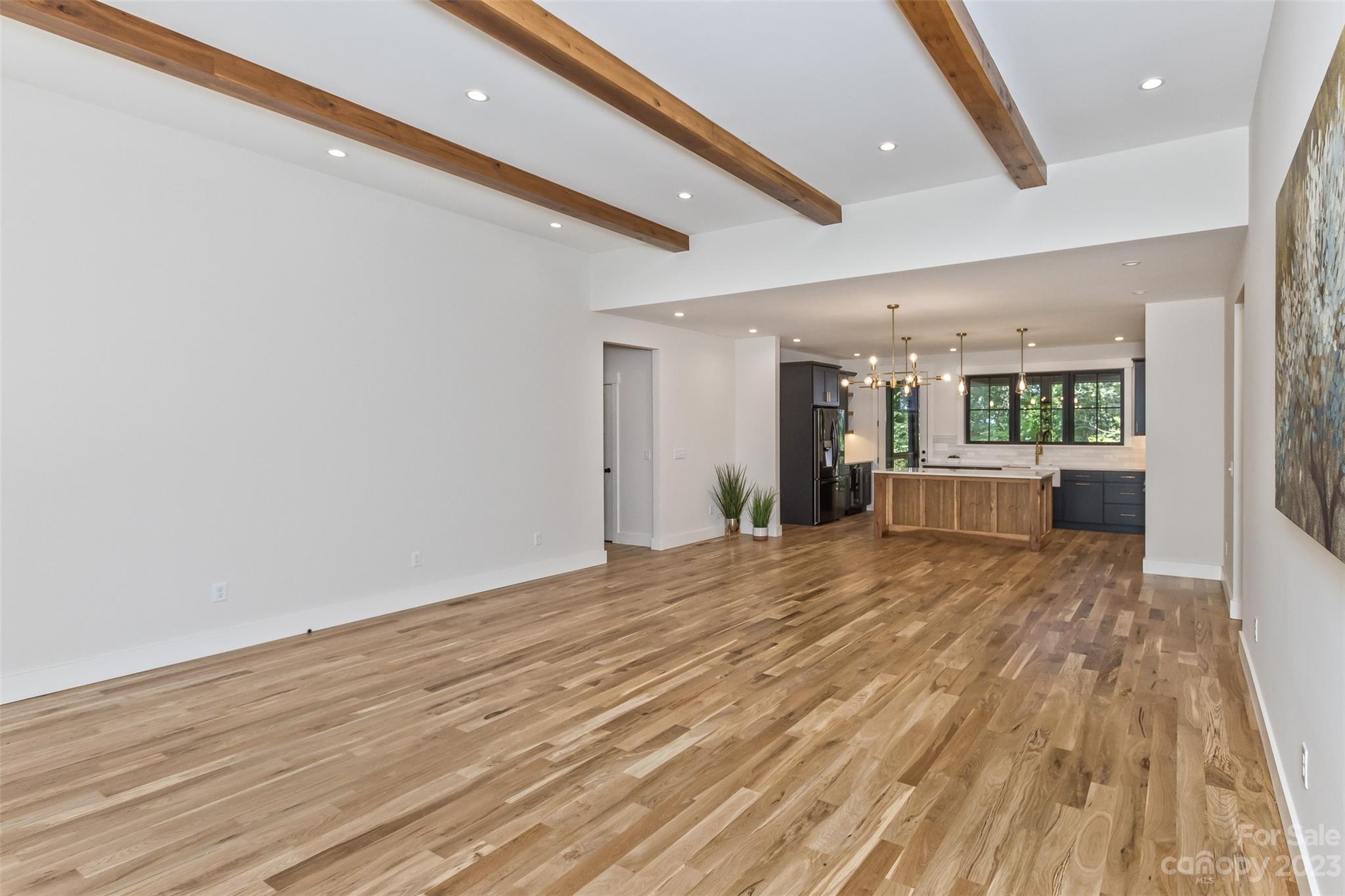 159 Gashes Creek Road Asheville, NC 28805 - Photo 6 of 48 a view of a livingroom with wooden floor and kitchen space