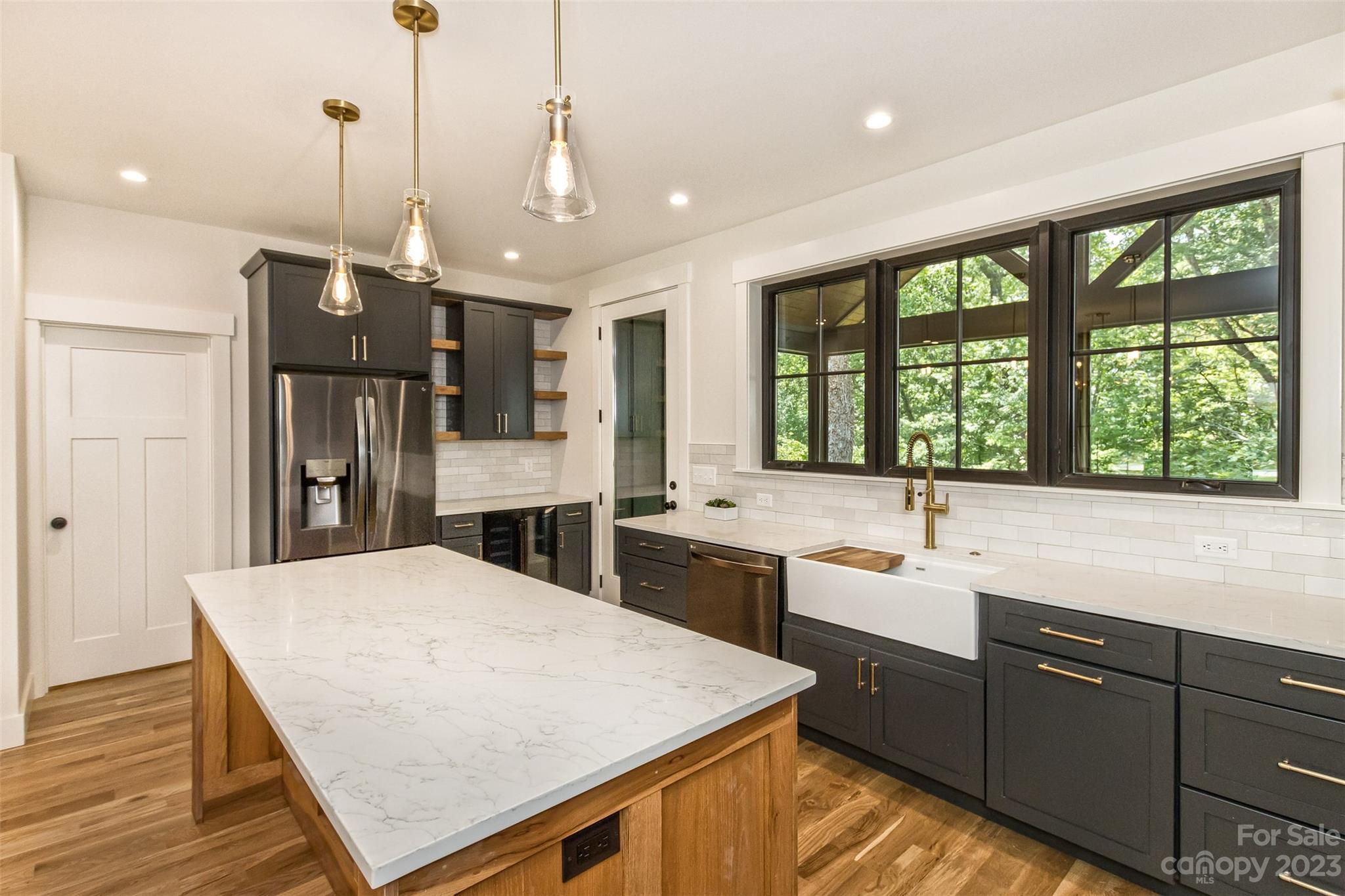 159 Gashes Creek Road Asheville, NC 28805 - Photo 9 of 48 a kitchen with stainless steel appliances granite countertop a sink a stove and a refrigerator