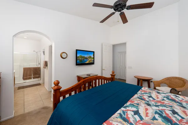 a bedroom with a bed and a chandelier