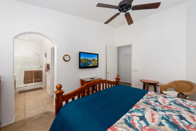 a bedroom with a bed and a chandelier