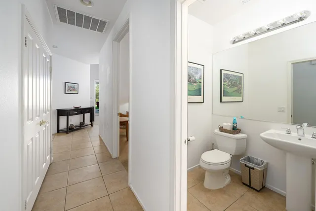 a bathroom with a toilet sink and a mirror