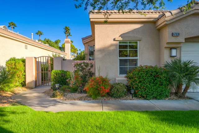 a view of a house with a yard and plants