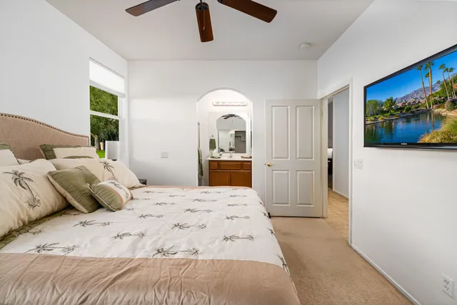 a bedroom with a bed and a painting on the wall