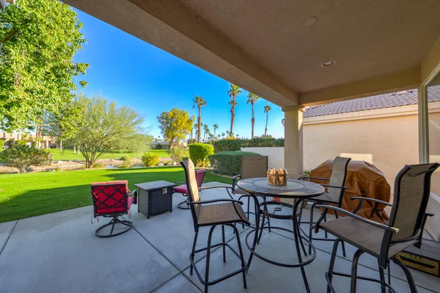 a patio with table and chairs