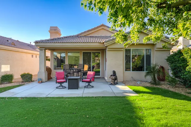 a view of a house with backyard porch and sitting area