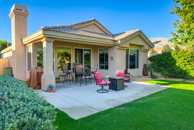 a view of a house with a swimming pool and sitting area