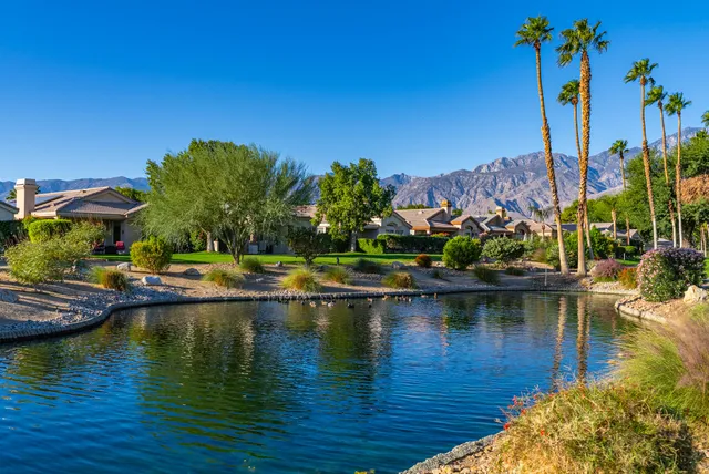 a view of swimming pool with outdoor seating and lake