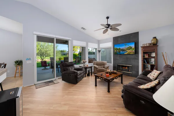 a living room with furniture a fireplace and a flat screen tv