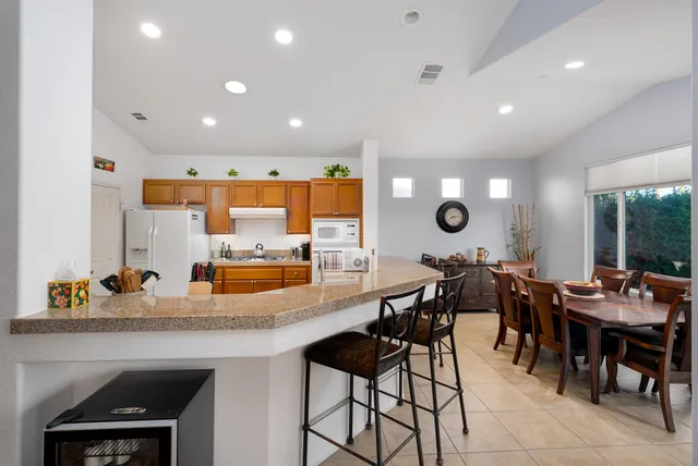 a kitchen with a dining table chairs and counter space
