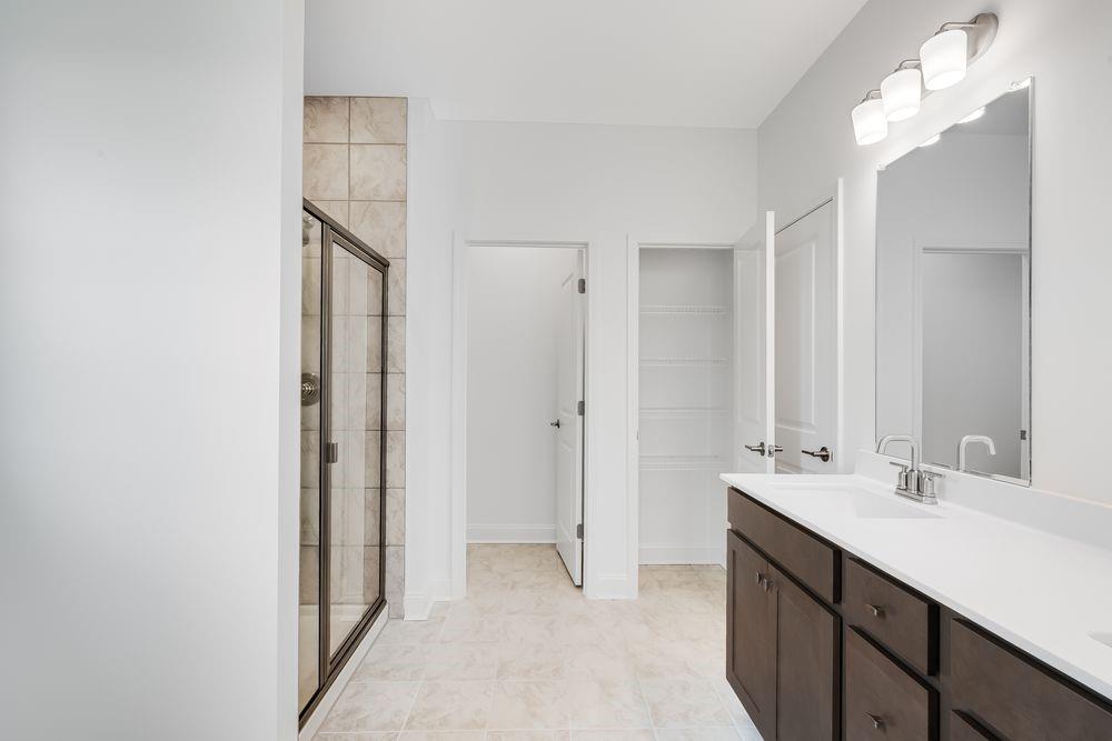 8810 Avonbrook Cl Ball Ground, GA 30107 - Photo 14 of 44 a bathroom with a sink and a mirror