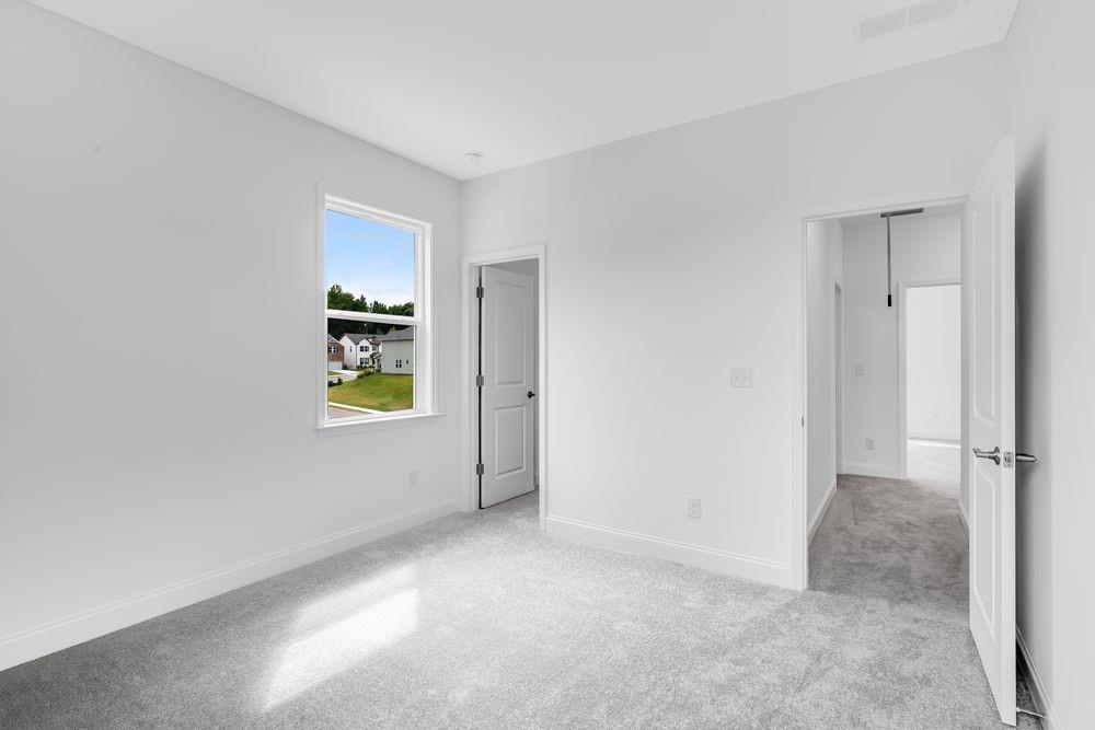 8810 Avonbrook Cl Ball Ground, GA 30107 - Photo 16 of 44 a view of an empty room with a window