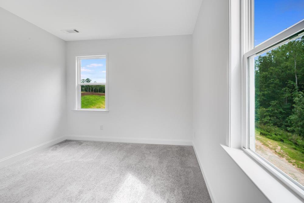 8810 Avonbrook Cl Ball Ground, GA 30107 - Photo 21 of 44 a view of an empty room with a window