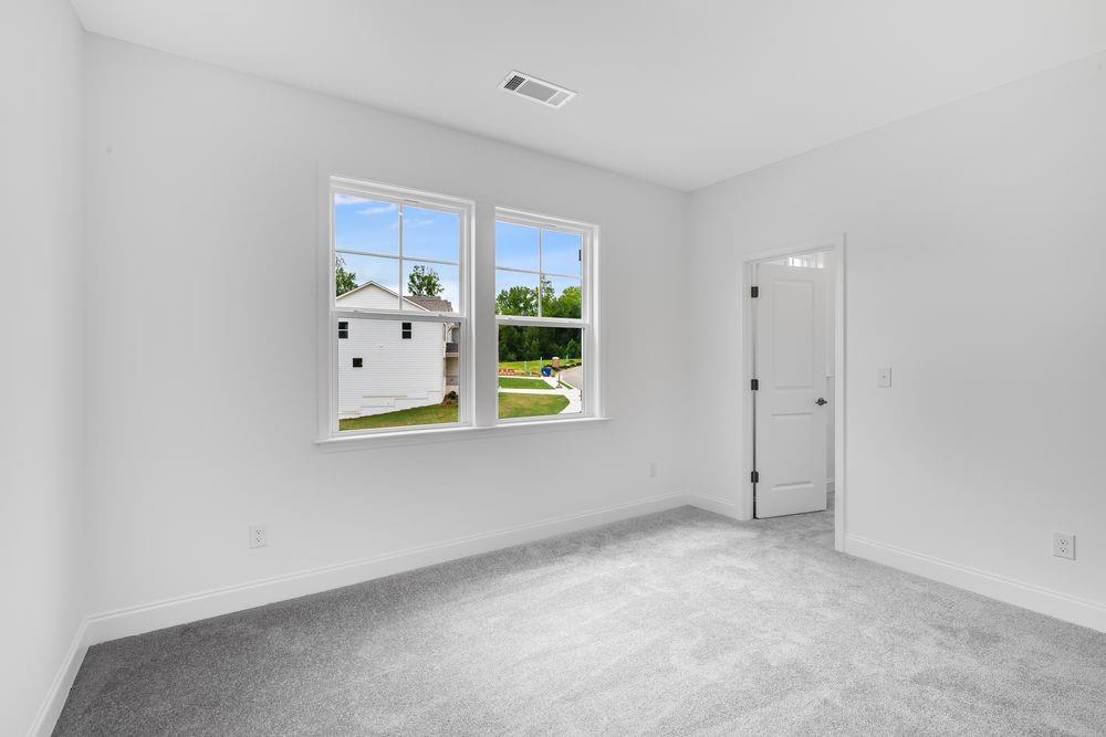 8810 Avonbrook Cl Ball Ground, GA 30107 - Photo 23 of 44 an empty room with windows