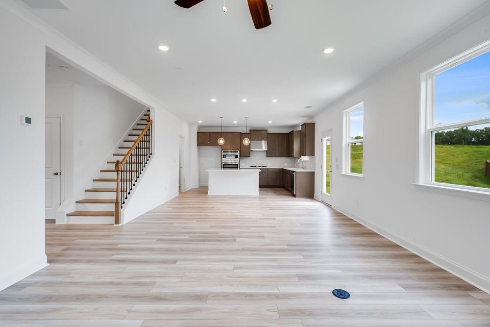 8810 Avonbrook Cl Ball Ground, GA 30107 - Photo 7 of 44 a view of kitchen and hall with wooden floor