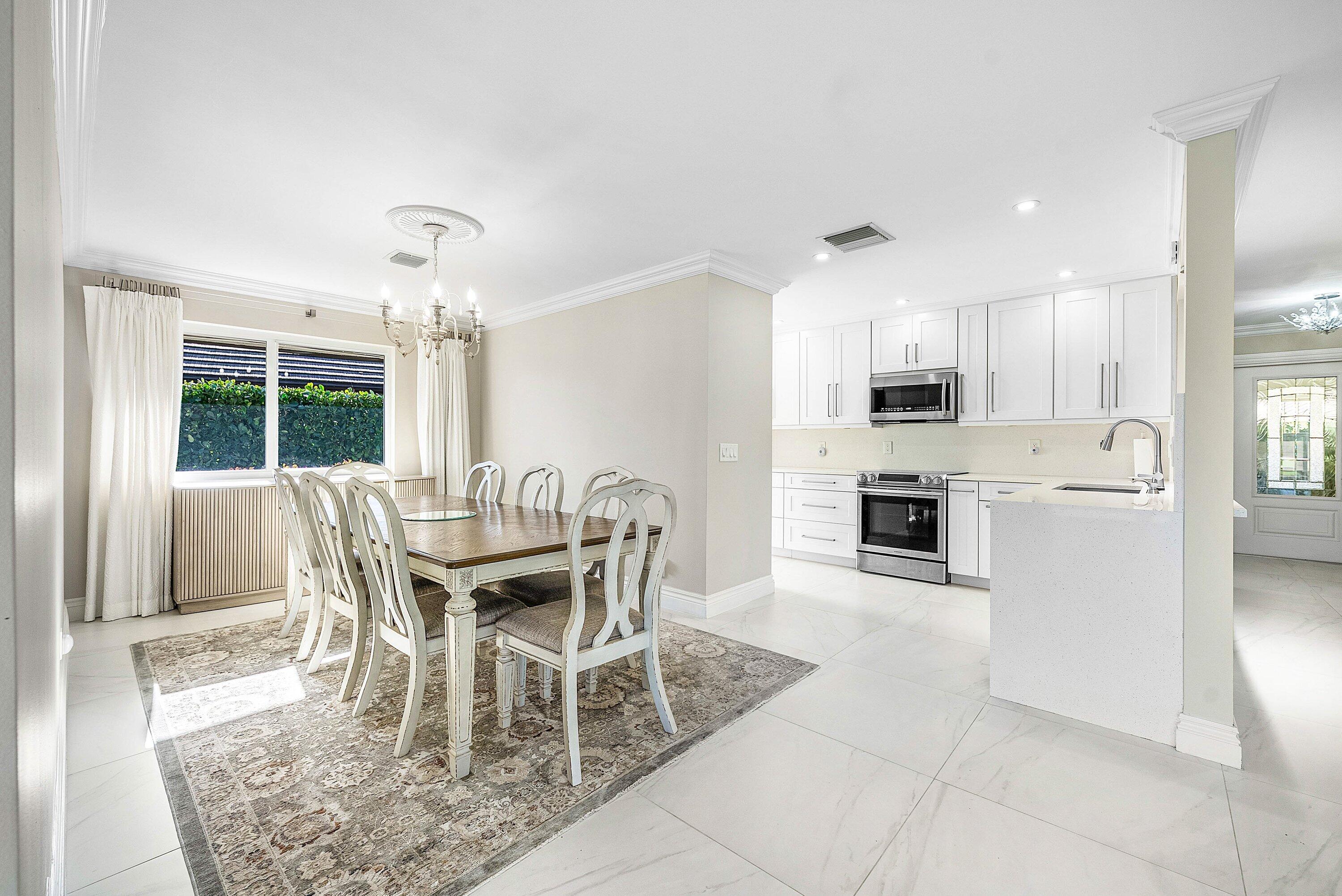 322 Cedar Key Circle Atlantis, FL 33462 - Photo 12 of 55 a dining room with furniture and window