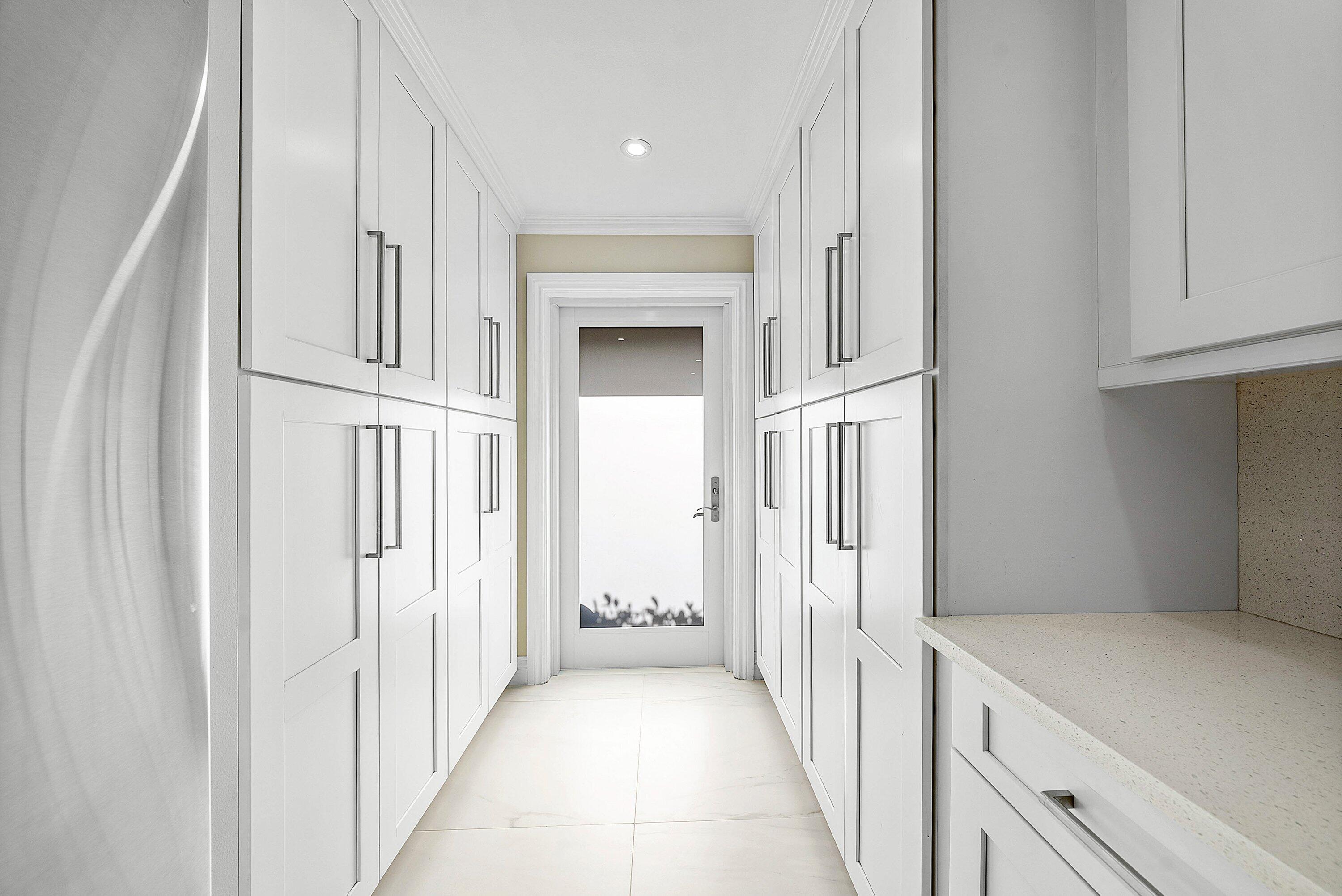 322 Cedar Key Circle Atlantis, FL 33462 - Photo 16 of 55 a view of a hallway with white cabinets