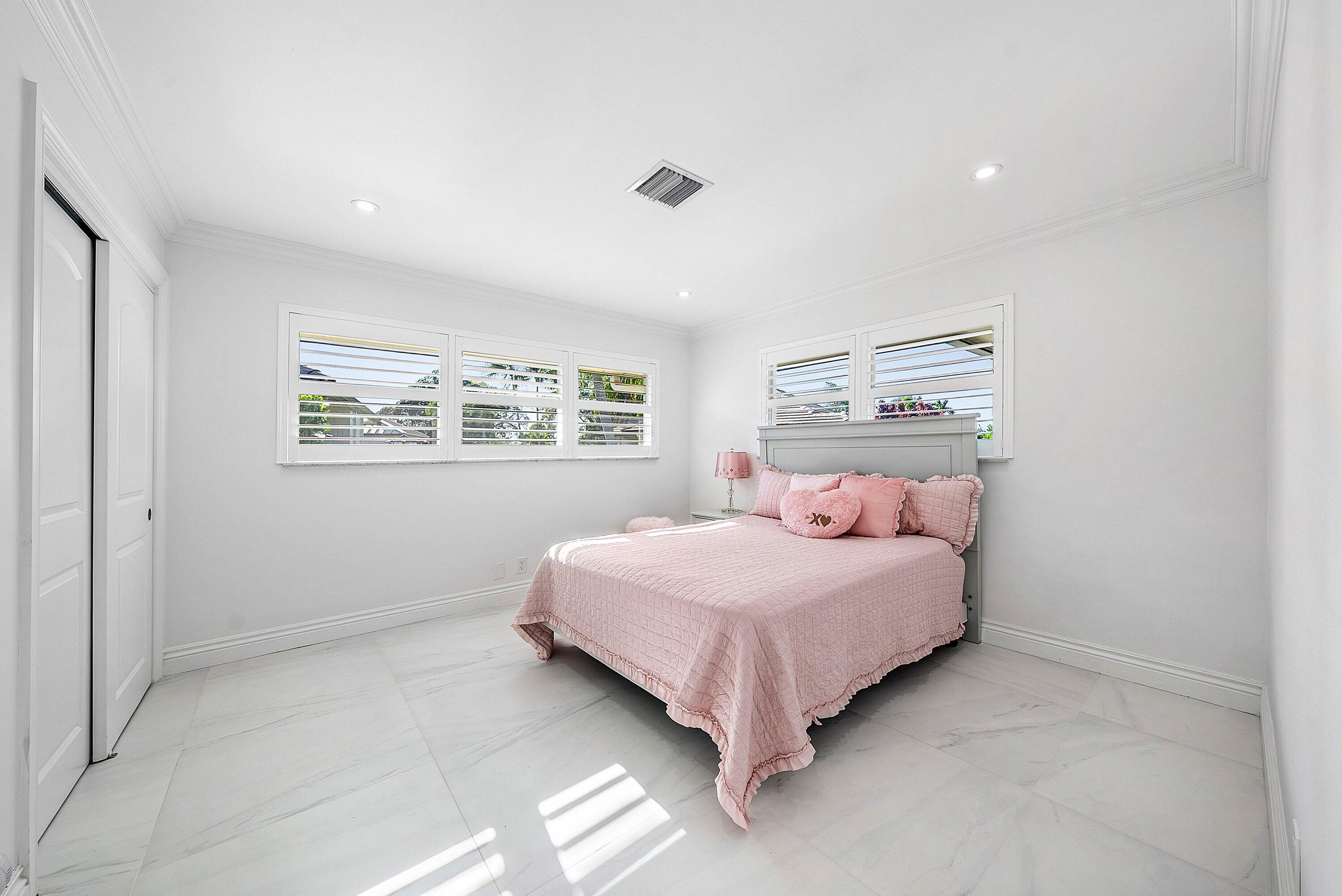 322 Cedar Key Circle Atlantis, FL 33462 - Photo 18 of 55 a bedroom with a bed and a window