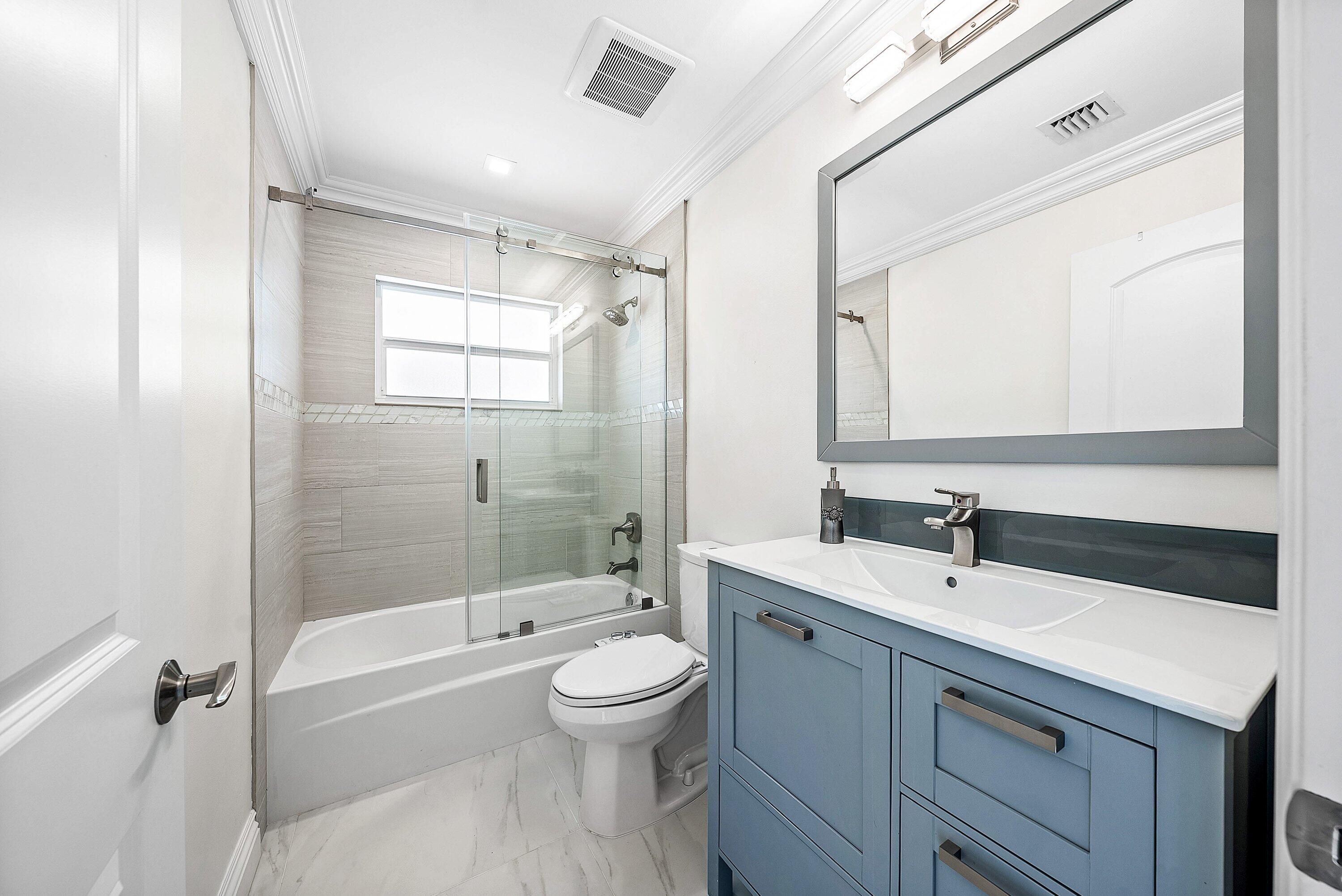 322 Cedar Key Circle Atlantis, FL 33462 - Photo 19 of 55 a bathroom with a sink a toilet and shower