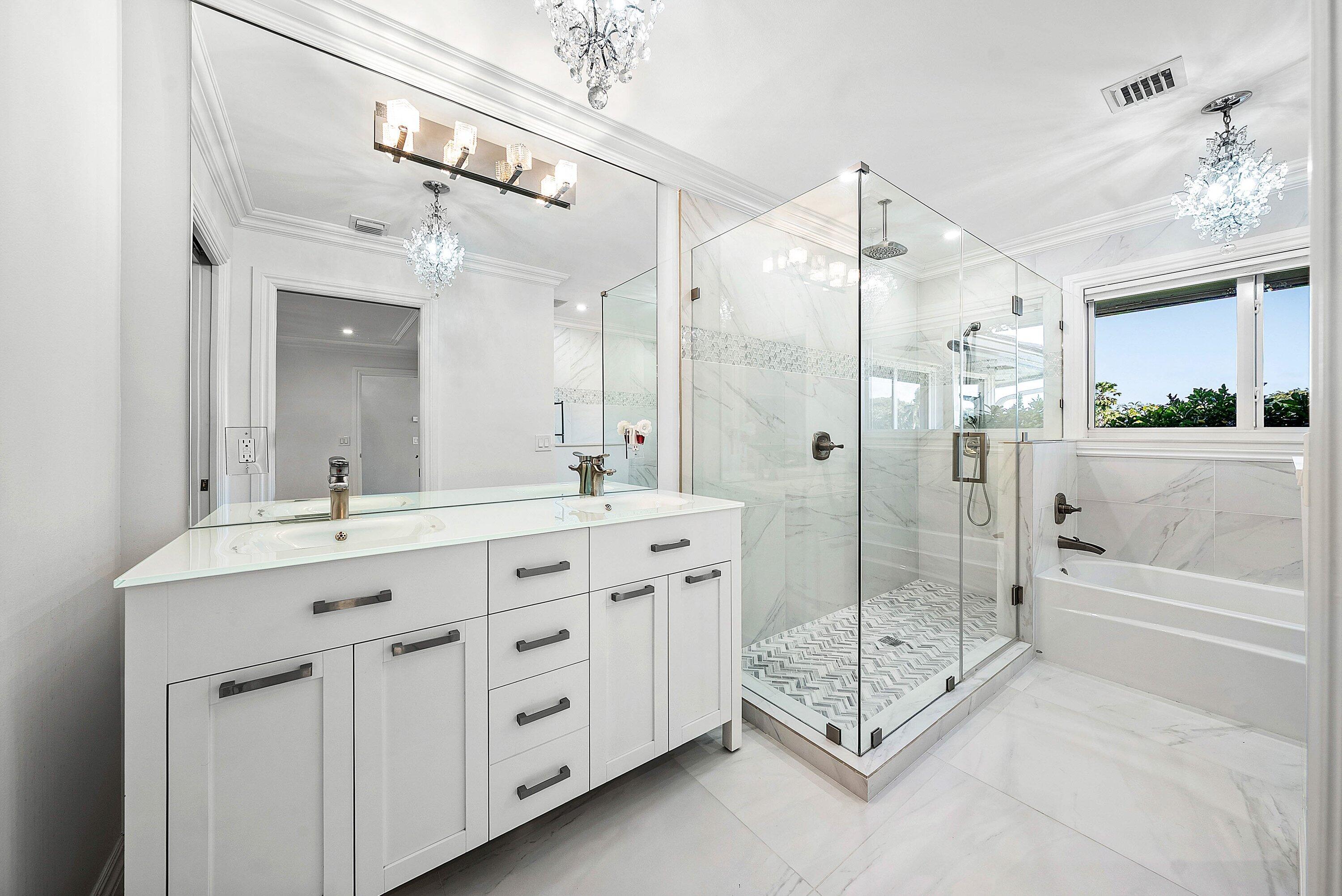322 Cedar Key Circle Atlantis, FL 33462 - Photo 22 of 55 a spacious bathroom with a shower tub double sink and mirror