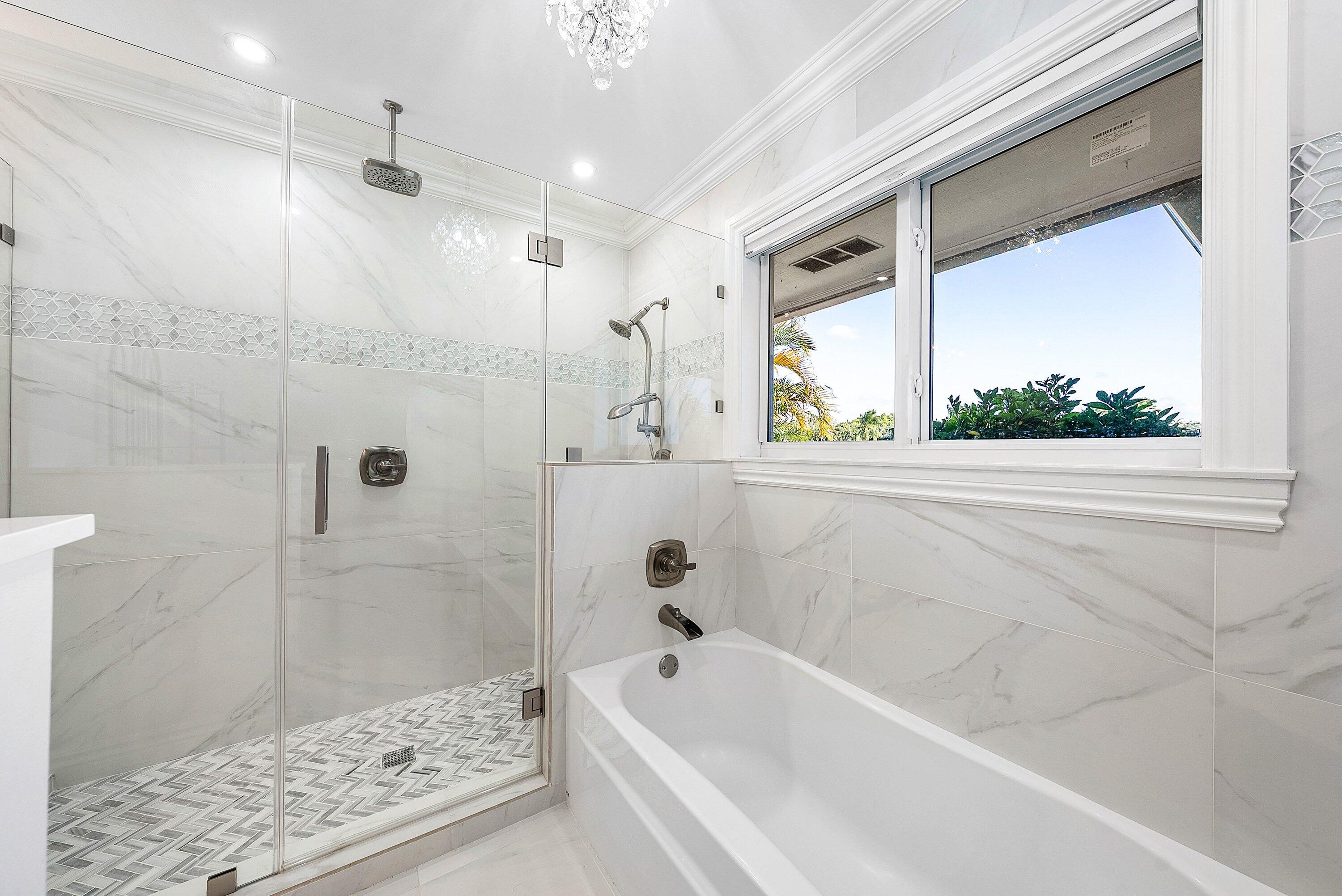 322 Cedar Key Circle Atlantis, FL 33462 - Photo 24 of 55 a bathroom with a bathtub and shower