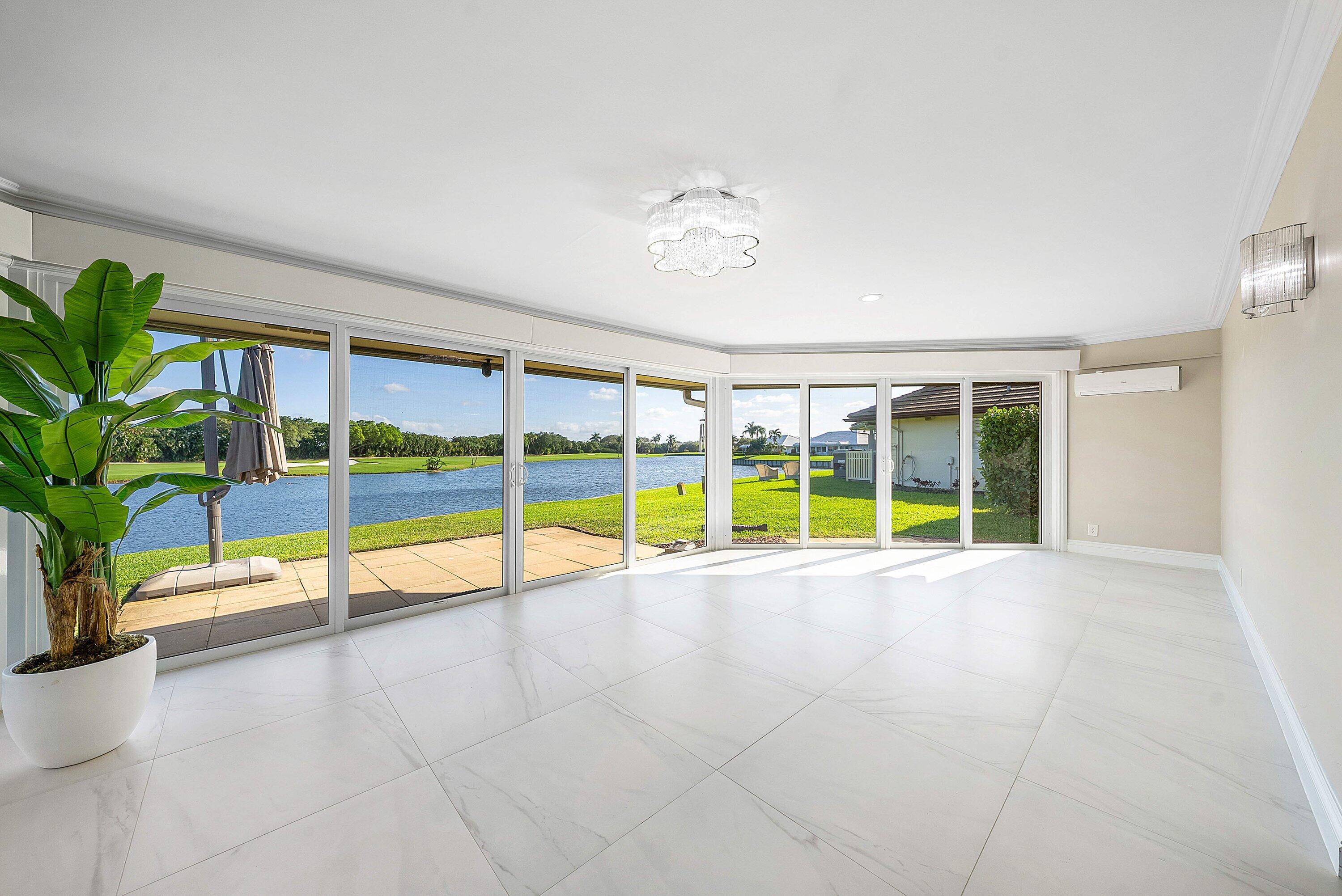 322 Cedar Key Circle Atlantis, FL 33462 - Photo 29 of 55 a view of an empty room with a window and potted plants