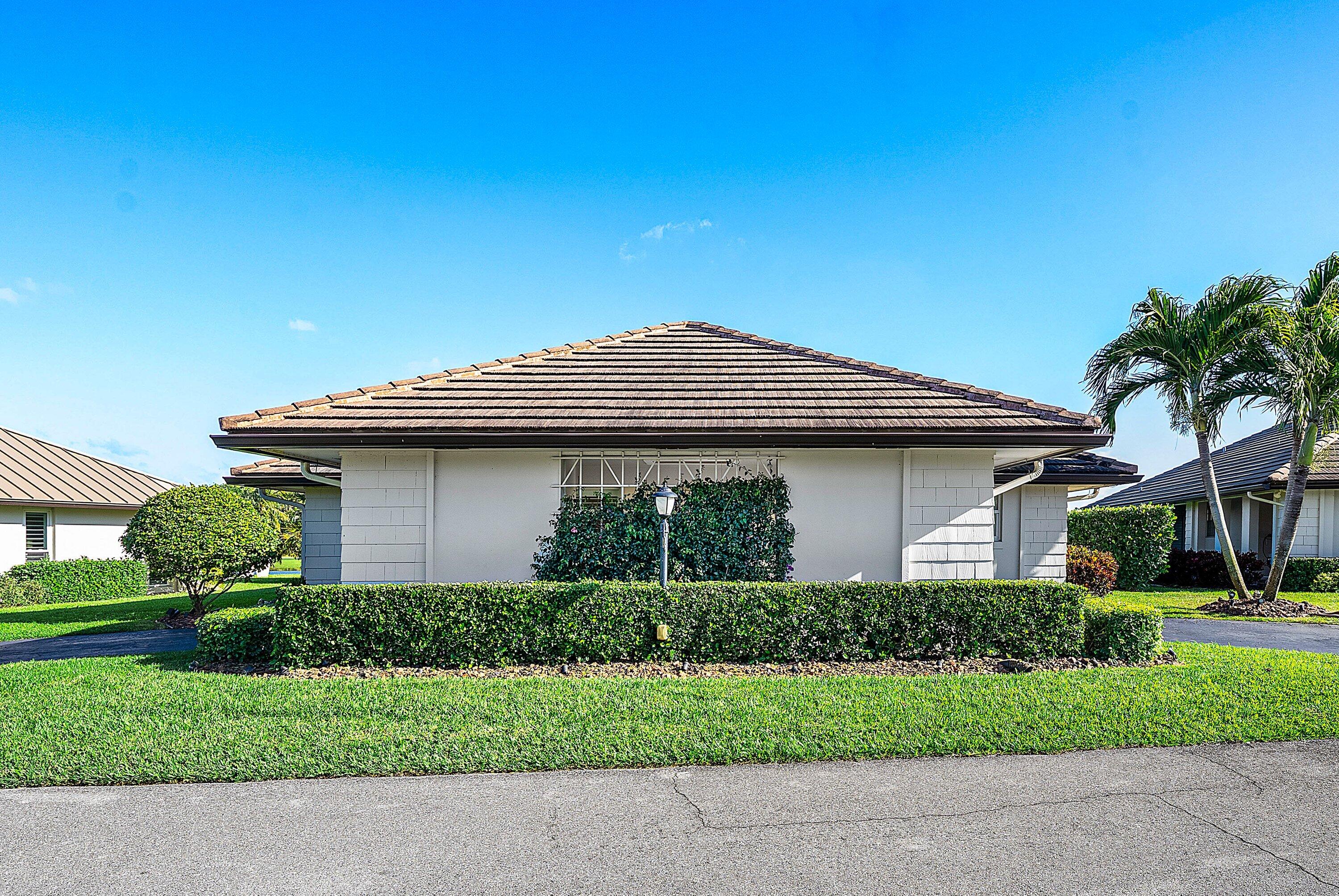 322 Cedar Key Circle Atlantis, FL 33462 - Photo 3 of 55 a front view of a house with a yard