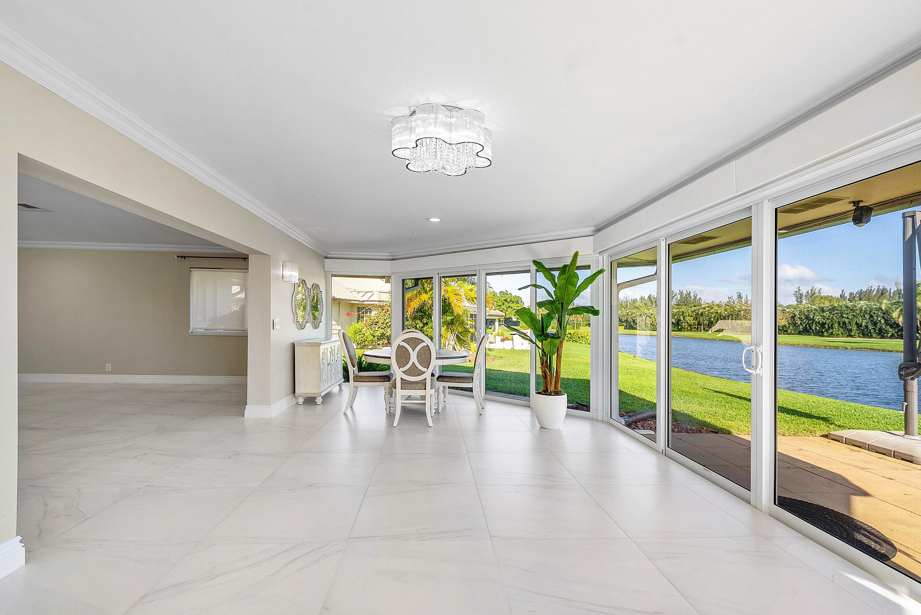 322 Cedar Key Circle Atlantis, FL 33462 - Photo 31 of 55 wooden floor with a lot of furniture and a large window