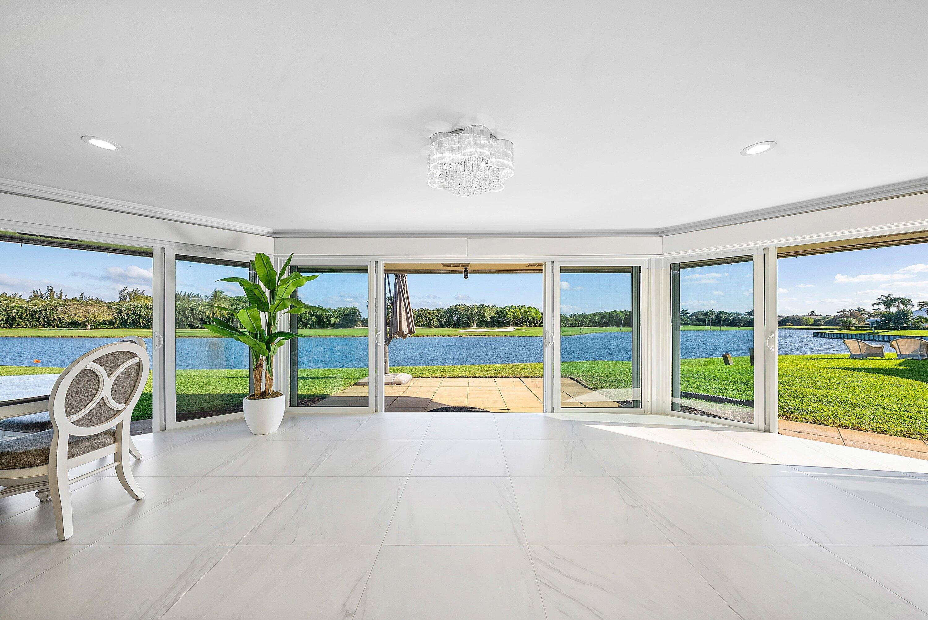322 Cedar Key Circle Atlantis, FL 33462 - Photo 32 of 55 a view of swimming pool with a garden and outdoor seating