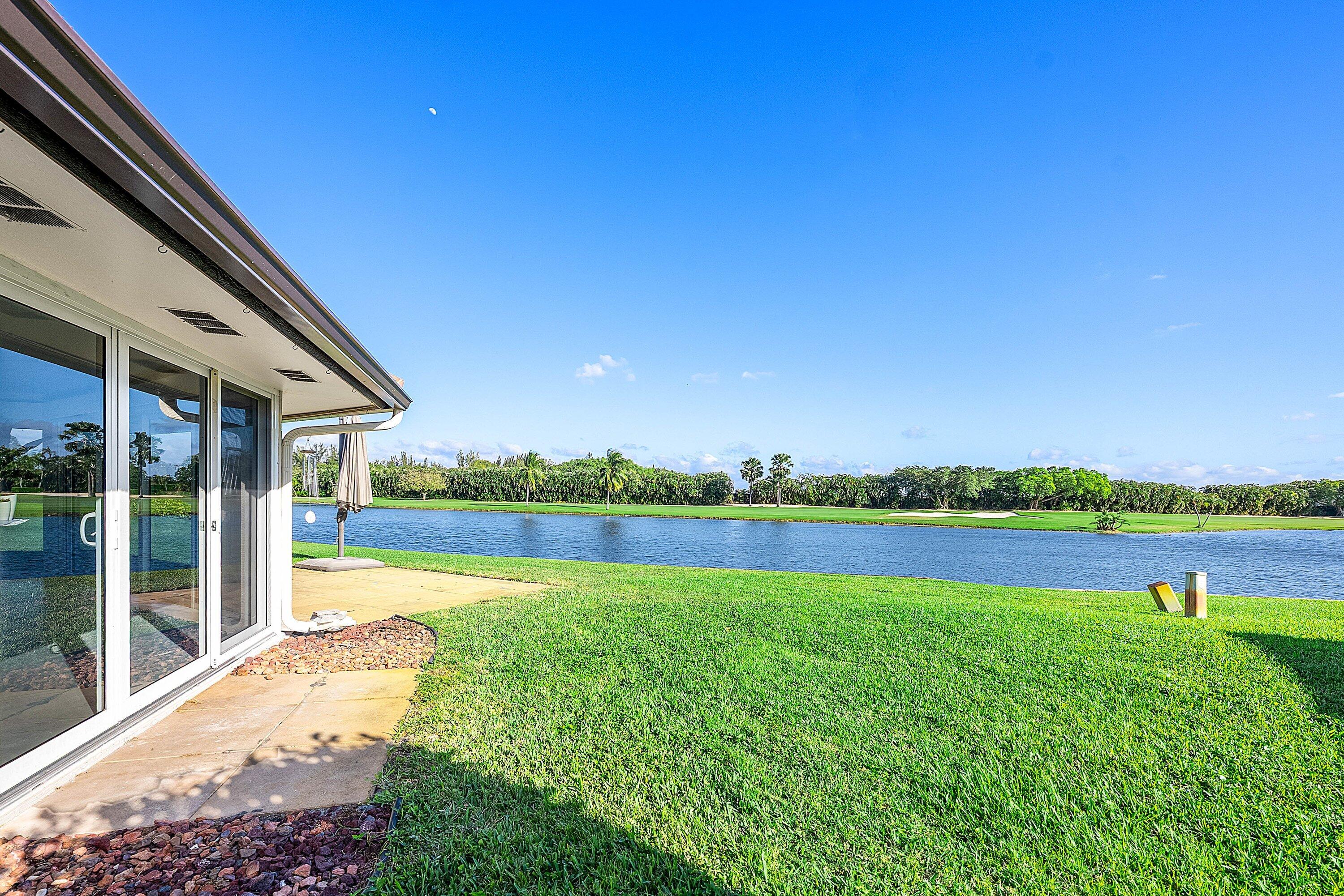 322 Cedar Key Circle Atlantis, FL 33462 - Photo 33 of 55 a view of outdoor space with swimming pool and green yard