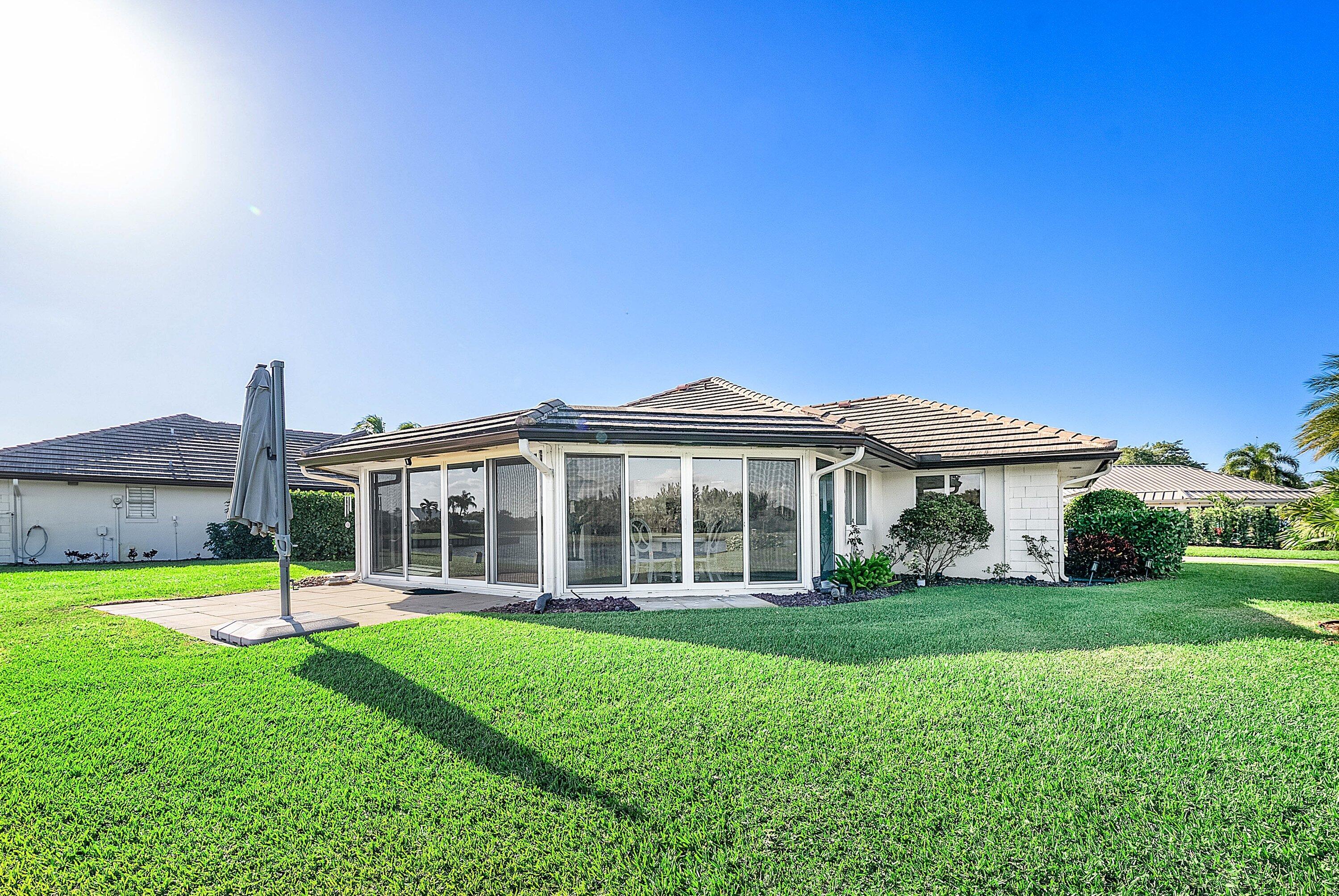 322 Cedar Key Circle Atlantis, FL 33462 - Photo 35 of 55 a view of a house with a yard and sitting area