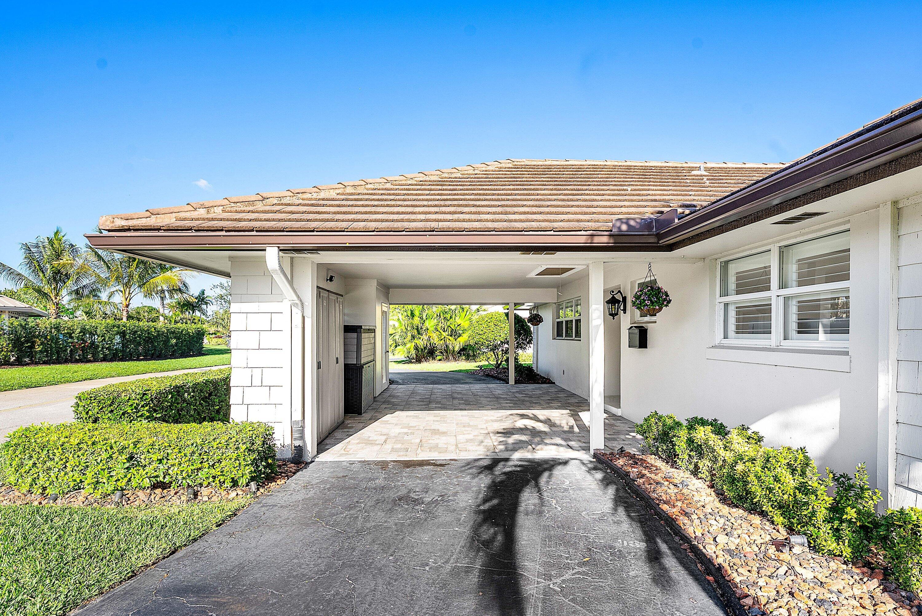 322 Cedar Key Circle Atlantis, FL 33462 - Photo 36 of 55 a view of a house with big yard and potted plants