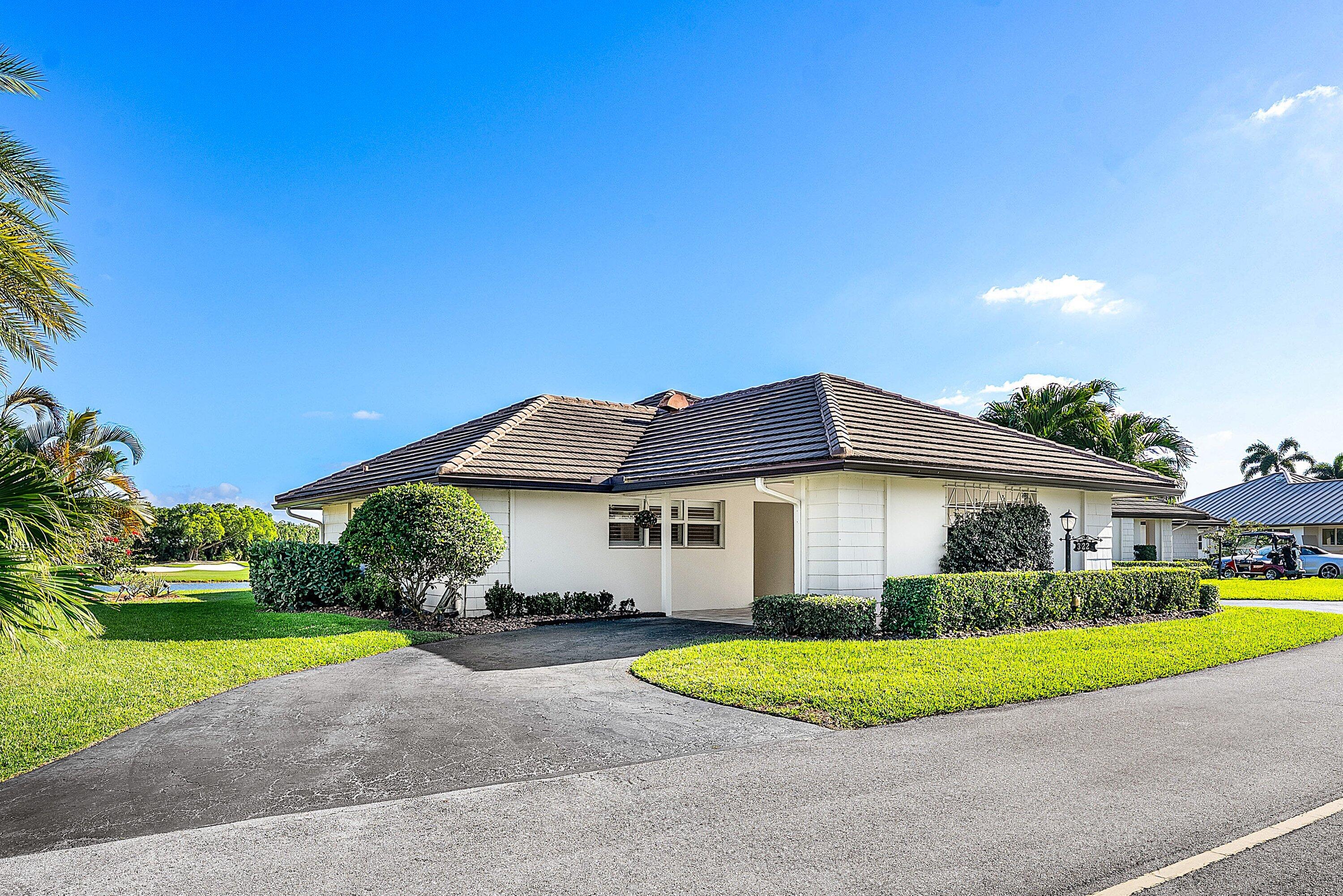 322 Cedar Key Circle Atlantis, FL 33462 - Photo 4 of 55 a view of a house with a yard and potted plants