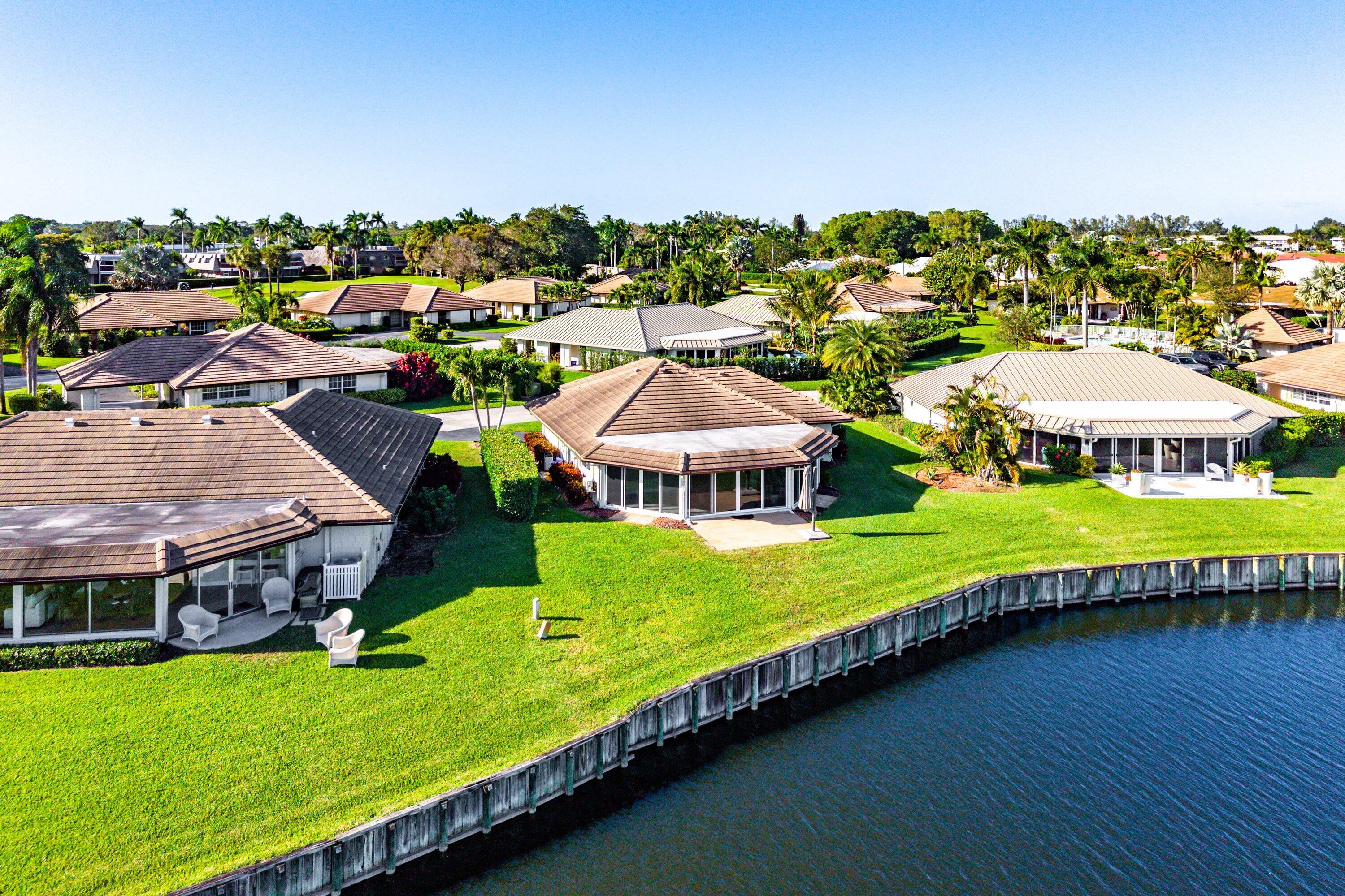 322 Cedar Key Circle Atlantis, FL 33462 - Photo 41 of 55 a view of a house with a garden and outdoor space
