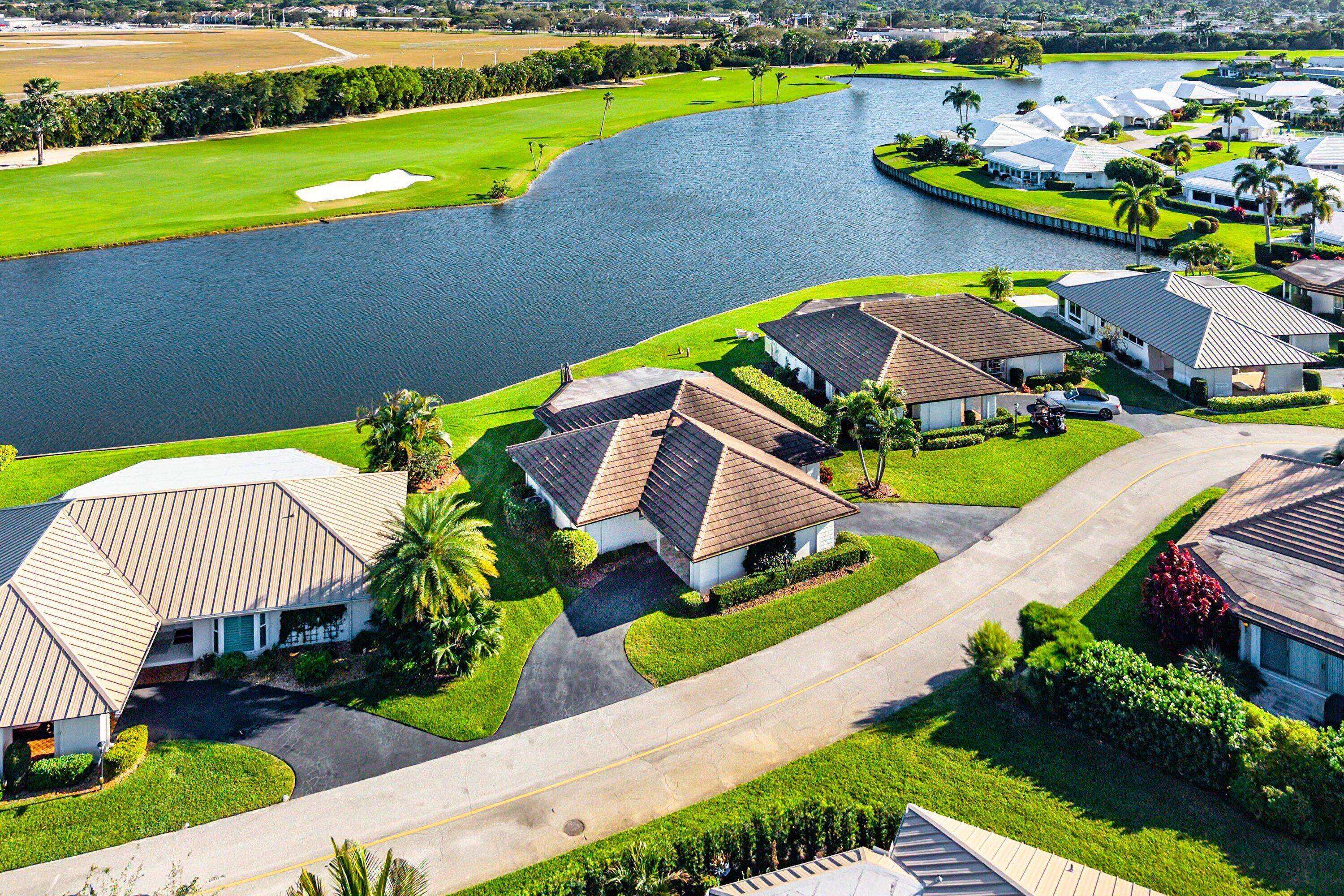 322 Cedar Key Circle Atlantis, FL 33462 - Photo 49 of 55 a view of a house with a yard and a sitting area