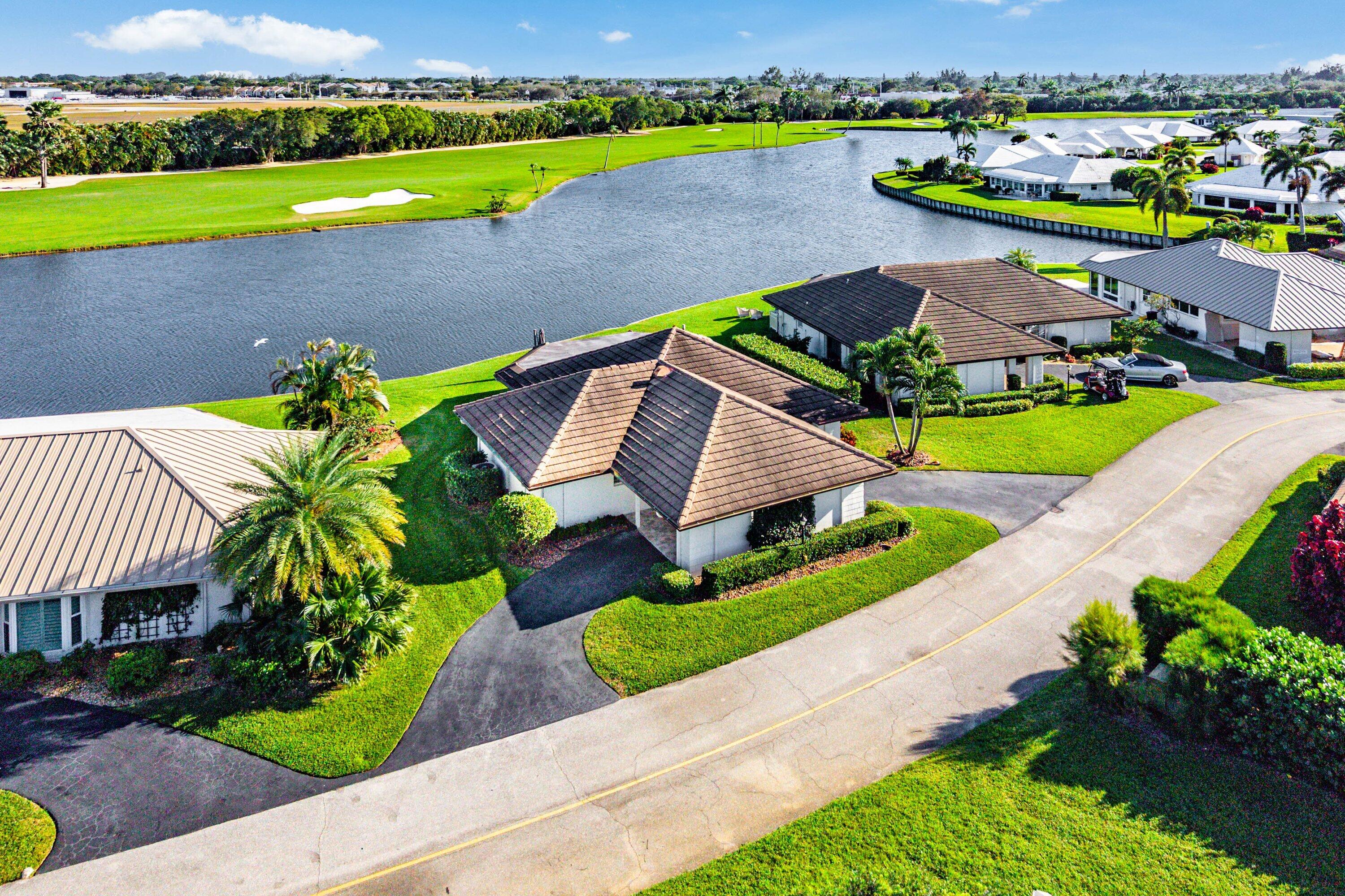 322 Cedar Key Circle Atlantis, FL 33462 - Photo 50 of 55 an aerial view of a house with a garden and lake view
