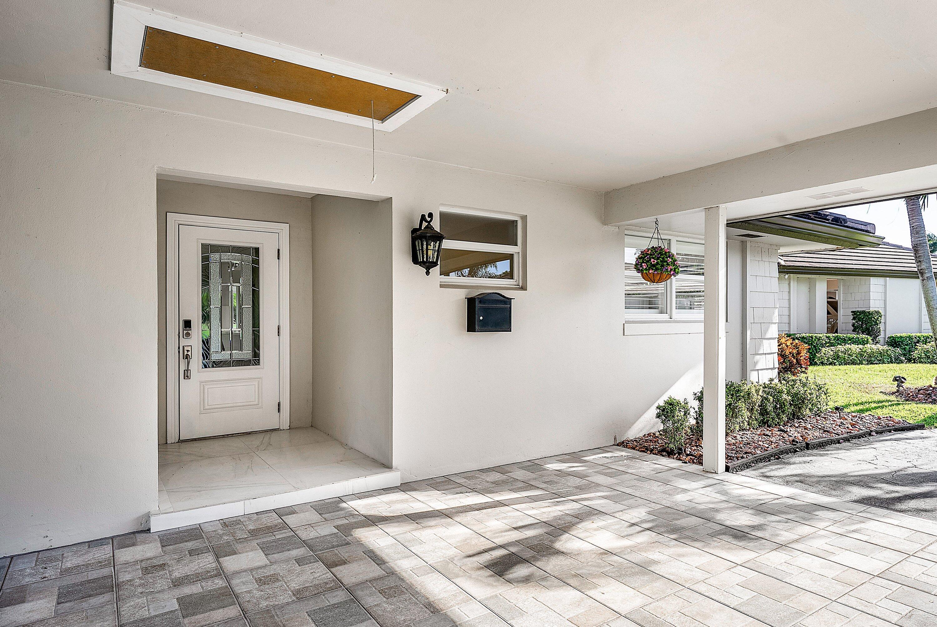 322 Cedar Key Circle Atlantis, FL 33462 - Photo 5 of 55 a view of a big room with a livingroom and front door