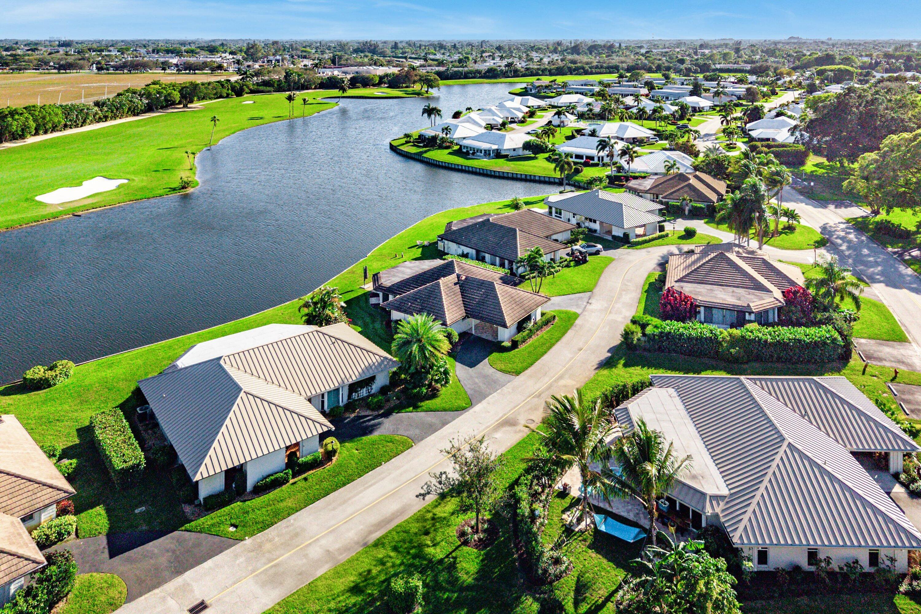 322 Cedar Key Circle Atlantis, FL 33462 - Photo 52 of 55 an aerial view of a house with a garden and lake view