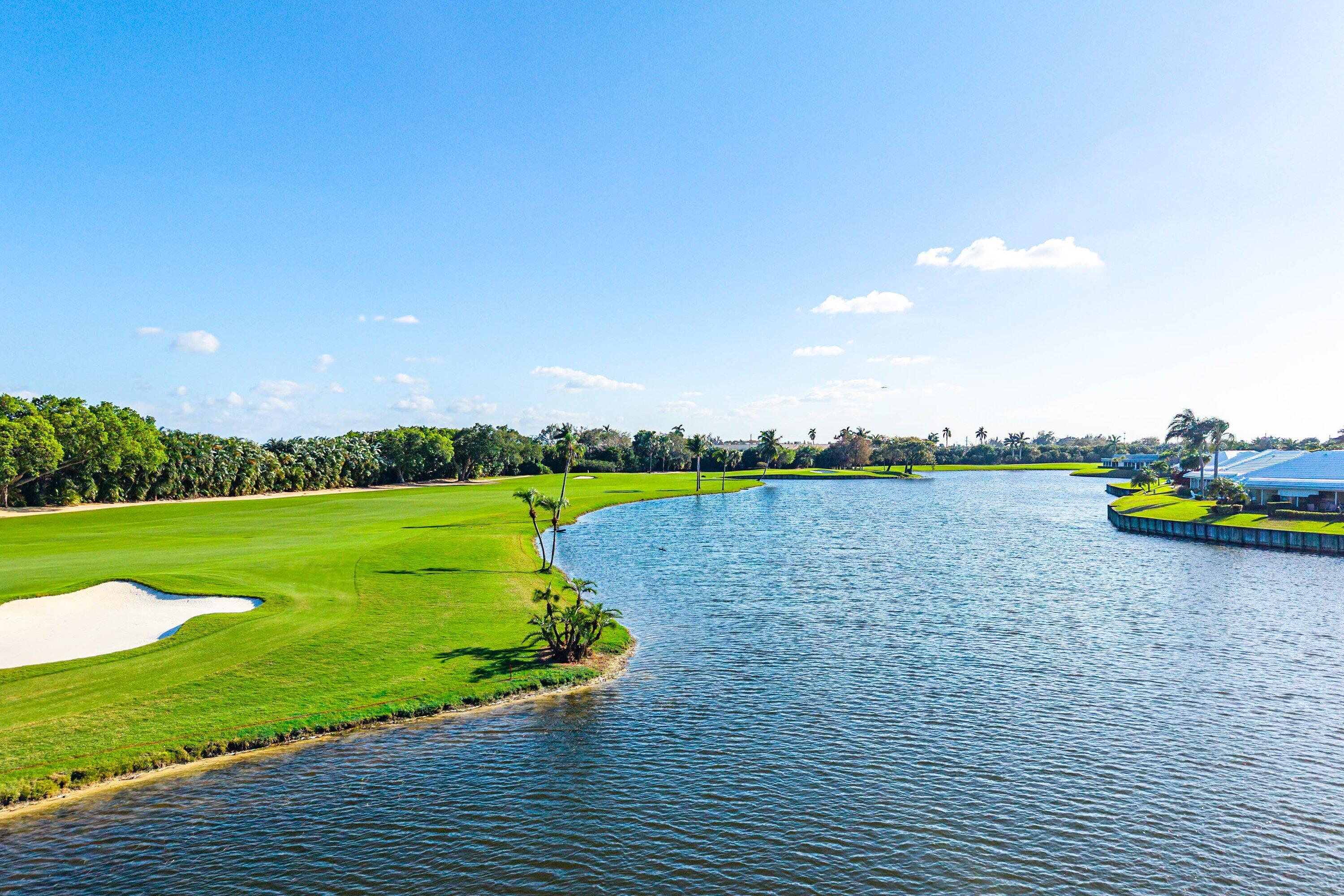322 Cedar Key Circle Atlantis, FL 33462 - Photo 55 of 55 a view of a lake with a yard